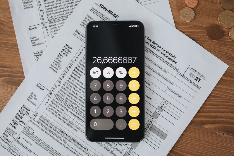Tax forms and a calculator representing crypto tax-loss harvesting rules