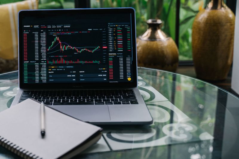 Laptop showing a crypto price chart as Ethereum staking rewards shift during the Lido staked ether migration
