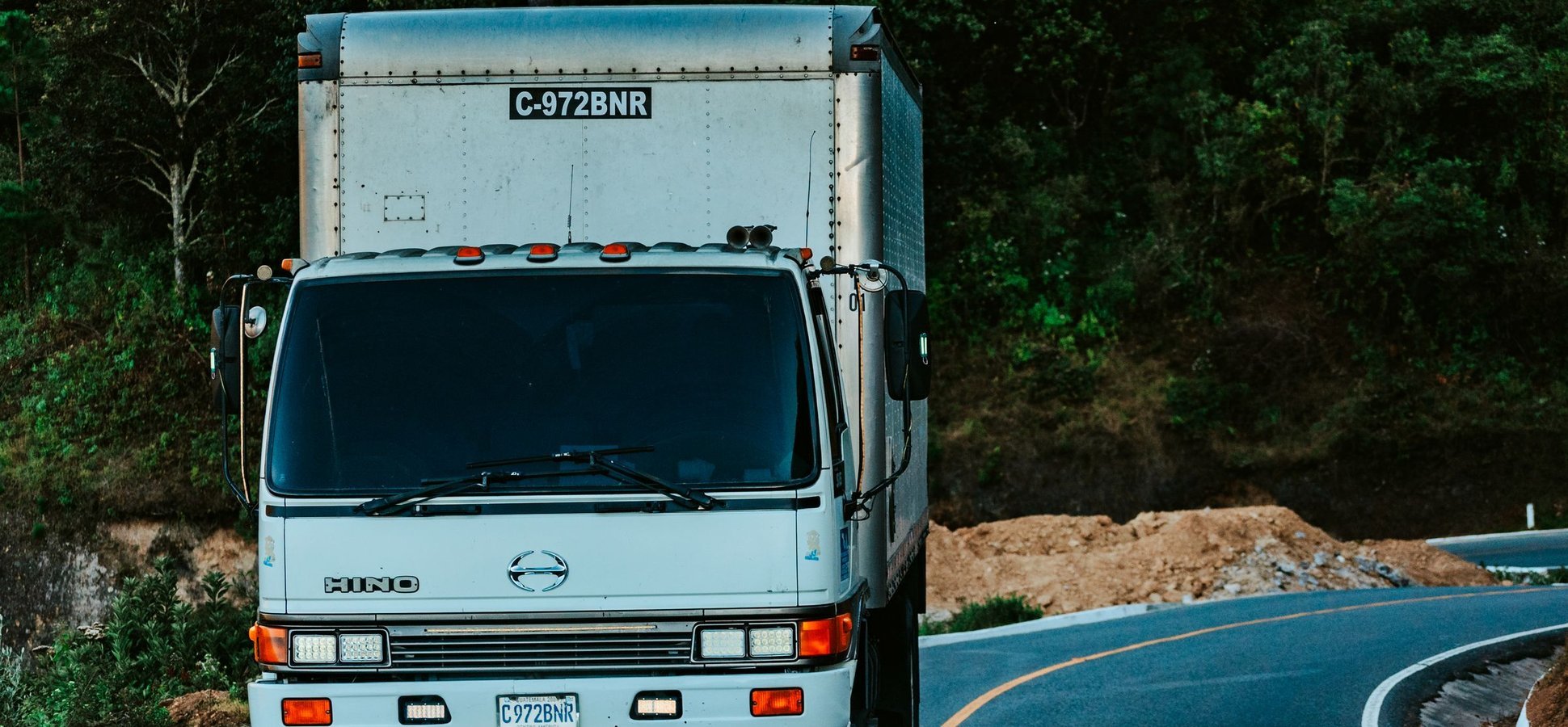 Japanese delivery truck on a road, illustrating AZ-COM Maruwa's JPYC stablecoin payments to logistics partners