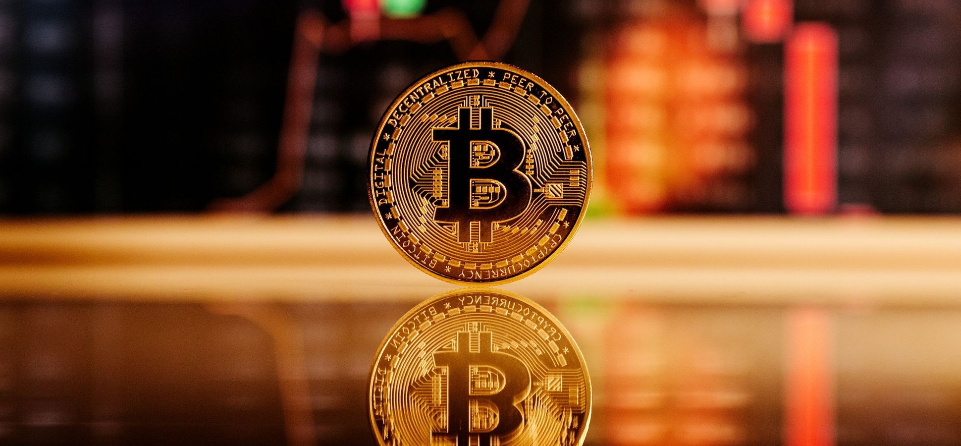 Bitcoin coin in front of a trading chart after the US government moved $288 million in seized bitcoin to Coinbase Prime