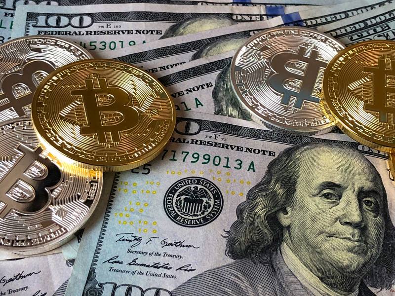 Bitcoin coins resting on US dollar bills, representing the 2,380 bitcoin Zhibao PIPE consideration