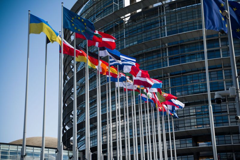 EU flags outside a government building representing MiCA crypto regulation enforcement