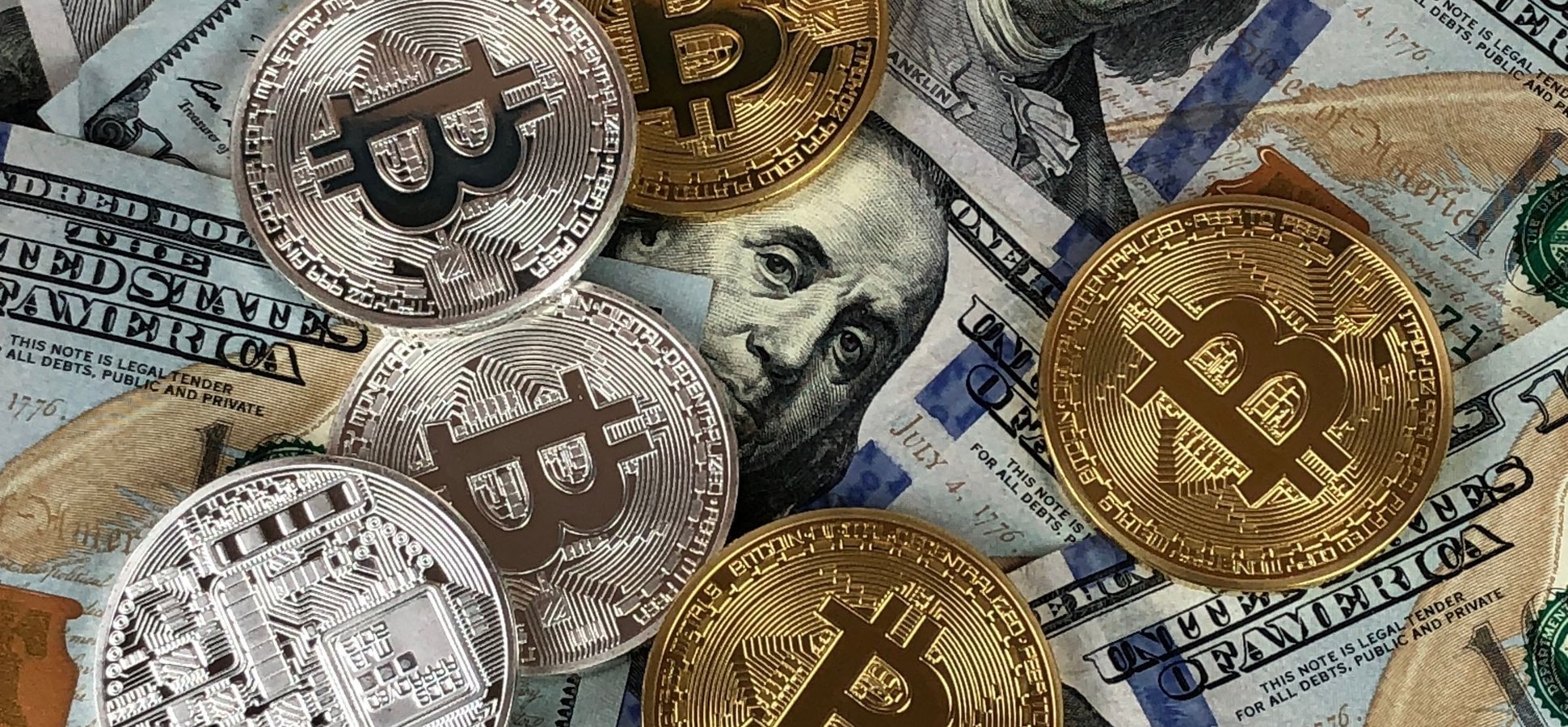 Bitcoin coins on US dollar bills illustrating the Trump Media bitcoin transfer to Crypto.com